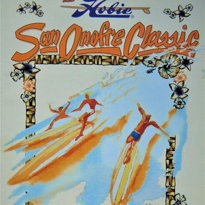 May include: A vintage poster advertising the Hobie San Onofre Classic, a longboard surfing competition. The poster features a watercolor illustration of three surfers riding waves, with a tropical floral border and the text "Vintage & Pro Longboard Contest, Tandem Paddleboard Race, Concours d'Elegance, May 6-7, 2000, Old Mans".