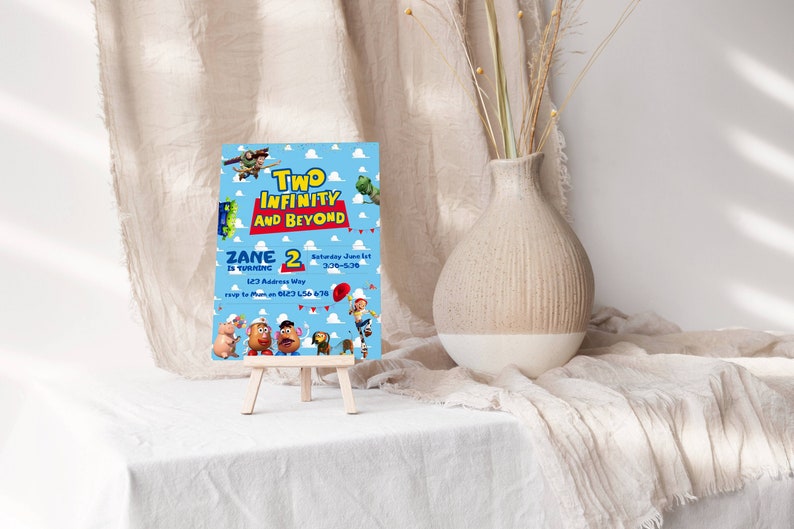 Puede incluir: Una invitaci&oacute;n de cumplea&ntilde;os azul y roja con personajes de Toy Story. La invitaci&oacute;n dice "Zane cumple 2 a&ntilde;os" y "Two Infinity and Beyond".