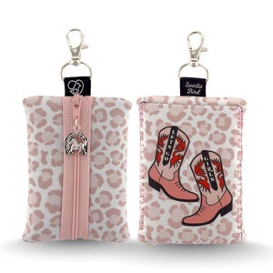 May include: Two rectangular pouches with a light pink and white leopard print. One pouch features a central pink zipper with a silver horseshoe charm. The other displays two pink cowboy boots with the text LETS GO GIRLS and a Sweetie Bird tag.