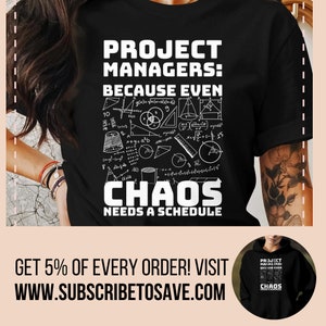May include: Black t-shirt with white text that reads "Project Managers: Because even chaos needs a schedule". The text is surrounded by various mathematical formulas and symbols.  The t-shirt is being worn by a person with tattoos on their arm.