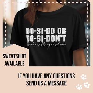 May include: Black t-shirt with white text that reads "DO-SI-DO OR DO-SI-DON'T That is the question".