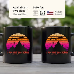May include: Two black 11oz and 15oz mugs with a retro sunset graphic and the text "I am not DB Cooper".