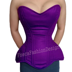 May include: A purple strapless corset with boning and a sweetheart neckline. The corset has a pointed bottom and the text "FnecaFashionDesign" is printed on the front.