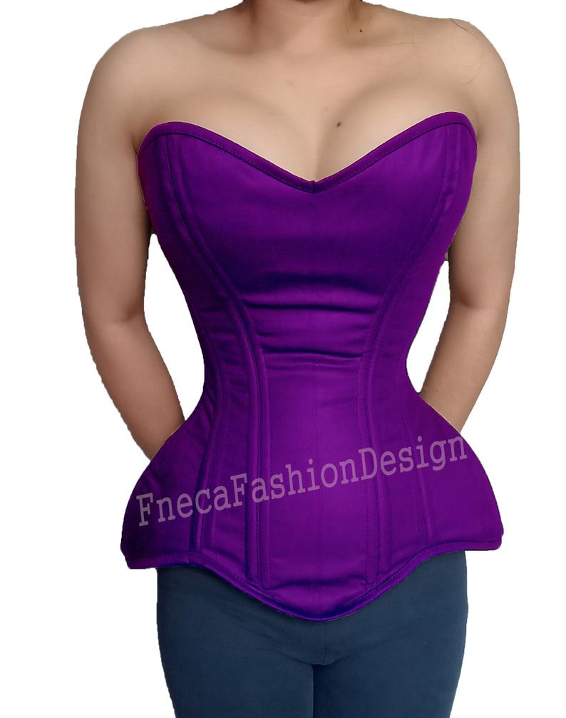May include: A purple strapless corset with boning and a sweetheart neckline. The corset has a pointed bottom and the text "FnecaFashionDesign" is printed on the front.