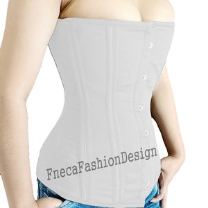 May include: A white corset with a busk closure and a FnecaFashionDesign logo. The corset is worn over a pair of blue jeans with a graphic print.