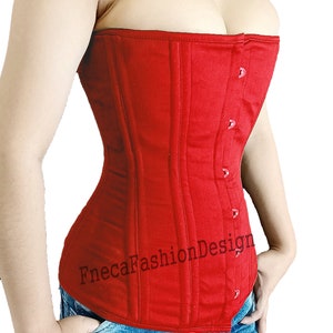 May include: A red cotton corset with a busk closure and a FnecaFashionDesign logo. The corset is worn over a pair of blue jeans with a graphic print.