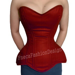May include: A red strapless corset with a sweetheart neckline and a pointed bottom. The corset has boning and is made of a smooth fabric. The text "FnecaFashionDesign" is printed on the front of the corset.