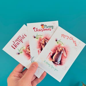 Conjunto de lindas tarjetas de Navidad y Año Nuevo: diseños ilustrados de conejitos y ratones: tarjetas de felicitación festivas