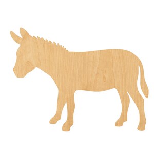 May include: A flat, light brown wooden cutout in the shape of a donkey standing in profile. The object features a smooth, natural wood grain texture and a distinct silhouette showing the animal's ears, mane, and tail in a simple, unpainted form.