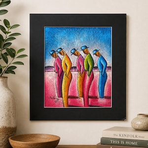 May include: A framed art print featuring five stylized figures wearing blue hats and colorful clothing in shades of pink, yellow, and green. The figures are positioned in a row against a textured blue sky and a pink ground. The artist signature Bilong is visible in the lower left corner of the artwork.