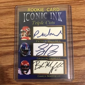 May include: A blue and gold rookie card with the title "Iconic Ink Triple Cuts" and three signatures: Patrick Mahomes, Saquon Barkley, and Baker Mayfield.
