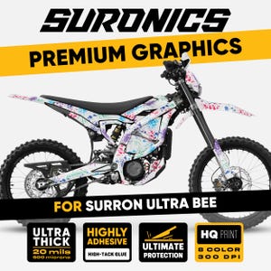 May include: White Surron Ultra Bee motorcycle with a colorful splatter paint design. The image includes text that reads "SURONICS PREMIUM GRAPHICS" and "FOR SURRON ULTRA BEE". Additional text highlights features like "ULTRA THICK 20 mils", "HIGHLY ADHESIVE", "ULTIMATE PROTECTION", and "HQ PRINT 8 COLOR 300 DPI".