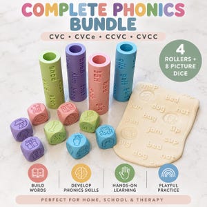 May include: A complete phonics bundle featuring four cylindrical rollers in green, purple, pink, and blue, each embossed with words. Eight small dice display various icons, and a beige rectangular mat shows embossed words and images.