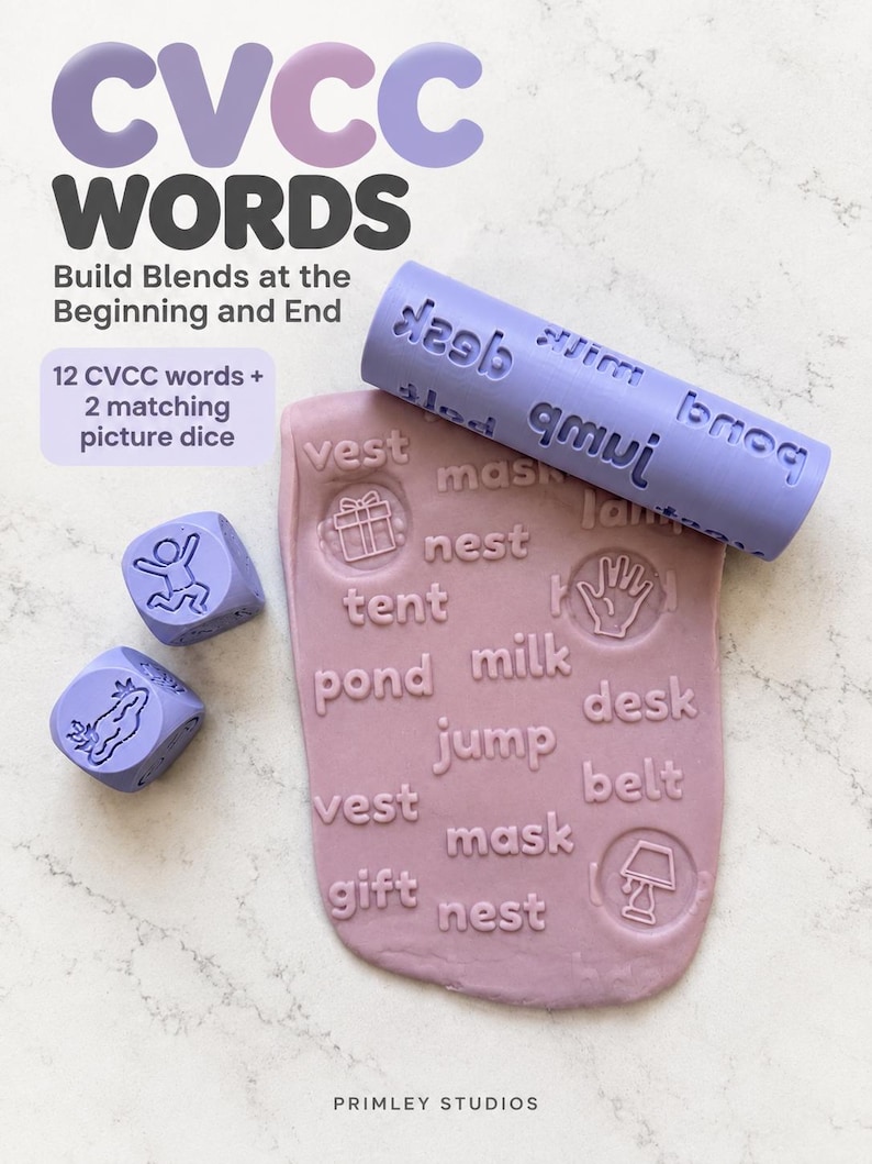 May include: A light purple rolling pin and two dice with embossed CVCC words and icons, used to imprint text into a flat piece of mauve modelling clay. The clay shows words like vest, mask, nest, tent, milk, jump, desk, belt, and gift.