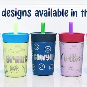 May include: Five colorful plastic tumblers with lids and straws, each featuring a unique design and a personalized name in silver lettering. The text 'more designs available in the shop' is displayed at the top of the image above the cups.