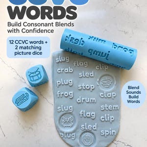 May include: A light blue rolling pin with embossed CCVC words, two matching light blue dice with icons, and a grey clay slab imprinted with words like slug, crab, plug, frog, flag, sled, stop, drum, clap, stem, clip, and spin.