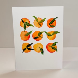 May include: A watercolor painting of nine orange fruits with green leaves. The fruits are arranged in a grid pattern on a white background.