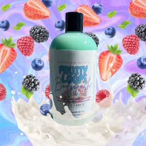 May include: A clear plastic bottle of Fruity Loops Bodywash with a green liquid inside. The bottle is surrounded by a white liquid and colorful fruit, including strawberries, blueberries, and raspberries. The label on the bottle reads "LOVE THE SKIN YOU'RE IN" and "FRUITY LOOPS BODYWASH". The bottle is 16 oz / 450 g.