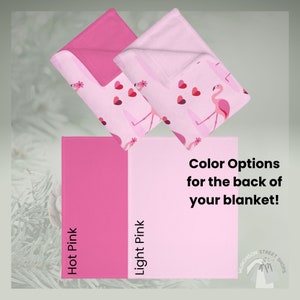 Sage green background with folded blankets showing the back color options of light pink or hot pink.