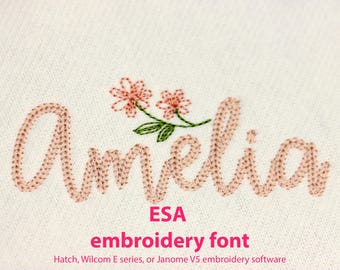 May include: Embroidered name "Amelia" in a pink script font with two pink flowers and green leaves. ESA embroidery font. Hatch, Wilcom E series, or Janome V5 embroidery software.