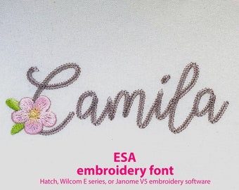 May include: Embroidered name "Camila" in a cursive font with a pink flower to the left of the name. The text "ESA embroidery font" is below the name, and the text "Hatch, Wilcom E series, or Janome V5 embroidery software" is below that.