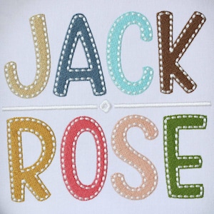 May include: Embroidered name "JACK ROSE" in colorful letters with a white background. The letters are outlined in white and have a stitched appearance.