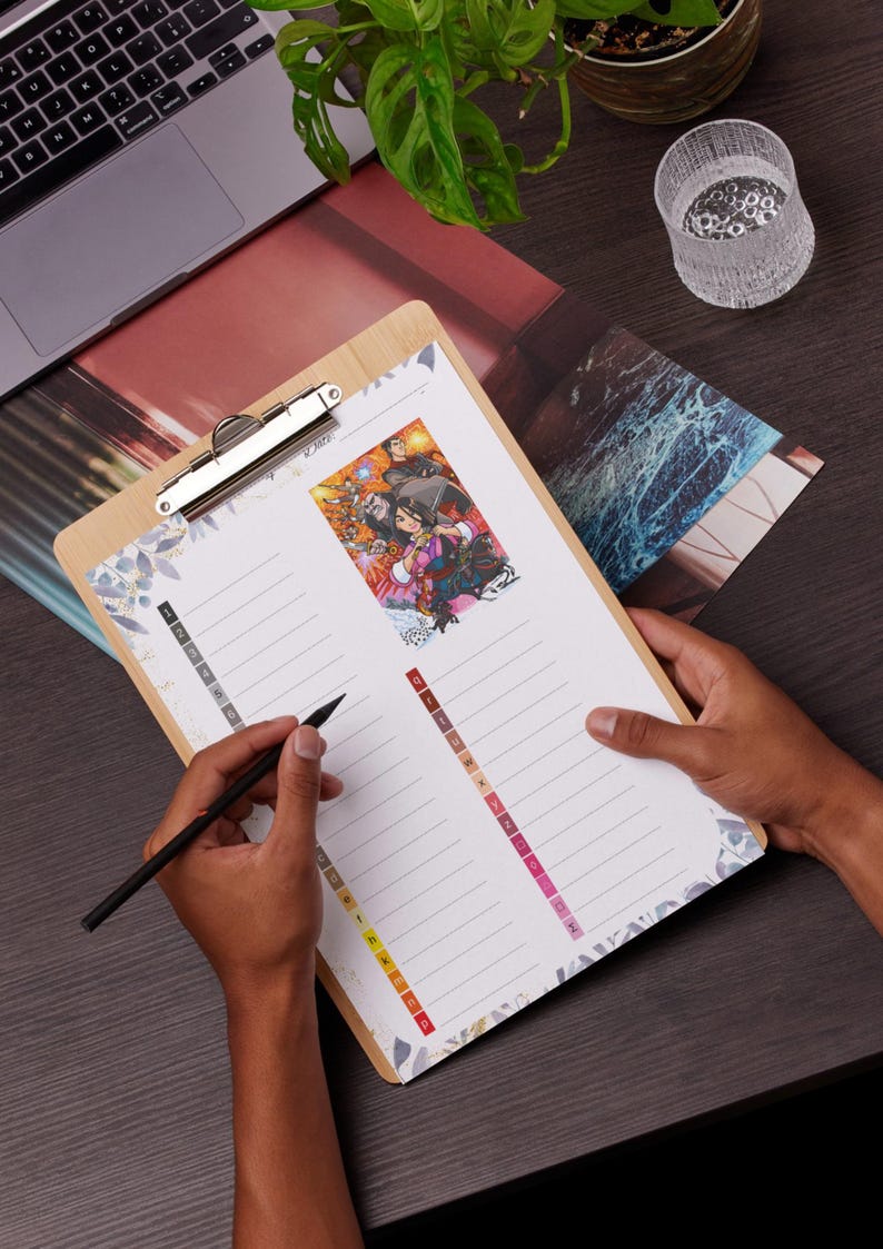 May include: A wooden clipboard with a silver clip holding a lined paper with a colourful illustration. The paper has a floral design on the edges and a series of coloured tabs. A black pen is held over the paper.