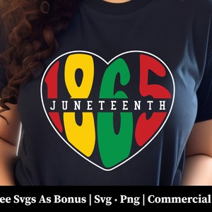 May include: A navy blue t-shirt with a heart-shaped design featuring the numbers 1865 in red, yellow, and green. The text "JUNETEENTH" is written in white across the heart.