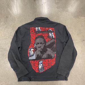 May include: Black jacket with a button closure and a collar. The back of the jacket features a red and black graphic print with the text "john coltrane" and a portrait of a person.