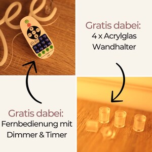 May include: White neon sign that says "Free" with a remote control and four clear acrylic wall mounts. The remote control has buttons for on/off, brightness, timer, and different light modes. The text "Gratis dabei: Fernbedienung mit Dimmer & Timer" is visible in the image. The text "Gratis dabei: 4 x Acrylglas Wandhalter" is also visible in the image.