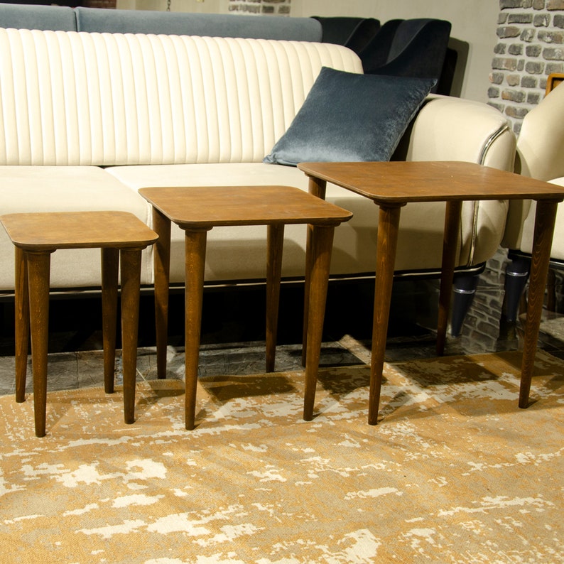 Here’s Square Walnut Wood Nesting End Table Set of 3! This Small Side Coffee Table will be absolutely fantastic Furniture Decor in your home. Your living room underwent a transformation with the addition of a Mid Century Modern style