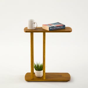 Narrow End Side Coffee Table with Storage

C Shape Couch Side Table | Solid Pine Wood Sofa End Table | Small Space Living Room Furniture

Designed for modern living and small spaces, this C shape narrow side table with storage combines elegance, durability, and functionality. Its slim profile allows it to slide easily under your couch or sofa, making it perfect for compact areas.
