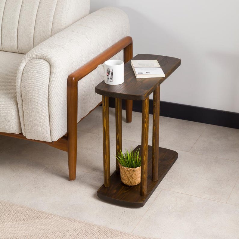 Narrow End Side Coffee Table with Storage

C Shape Couch Side Table | Solid Pine Wood Sofa End Table | Small Space Living Room Furniture

Designed for modern living and small spaces, this C shape narrow side table with storage combines elegance, durability, and functionality. Its slim profile allows it to slide easily under your couch or sofa, making it perfect for compact areas.