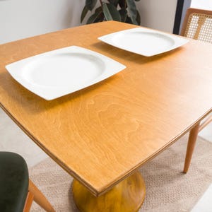 We combine rounded square dining table for two with tulip leg. Here is dark walnut wood 2 to 4 person dining room table as a kitchen furniture! This table with tulip leg will be absolutely fantastic small space table in your kitchen or apartment.