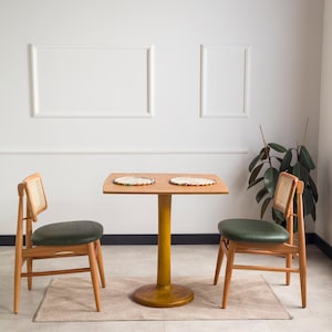 We combine rounded square dining table for two with tulip leg. Here is dark walnut wood 2 to 4 person dining room table as a kitchen furniture! This table with tulip leg will be absolutely fantastic small space table in your kitchen or apartment.