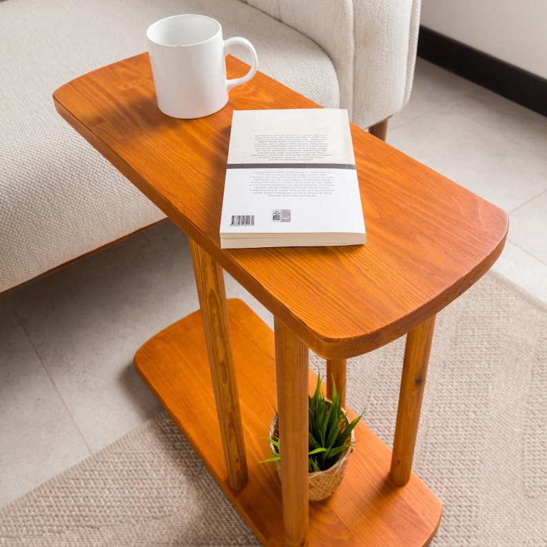 Narrow End Side Coffee Table with Storage

C Shape Couch Side Table | Solid Pine Wood Sofa End Table | Small Space Living Room Furniture

Designed for modern living and small spaces, this C shape narrow side table with storage combines elegance, durability, and functionality. Its slim profile allows it to slide easily under your couch or sofa, making it perfect for compact areas.