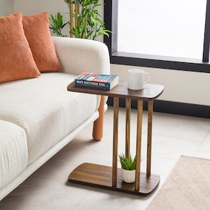 Narrow End Side Coffee Table with Storage

C Shape Couch Side Table | Solid Pine Wood Sofa End Table | Small Space Living Room Furniture

Designed for modern living and small spaces, this C shape narrow side table with storage combines elegance, durability, and functionality. Its slim profile allows it to slide easily under your couch or sofa, making it perfect for compact areas.