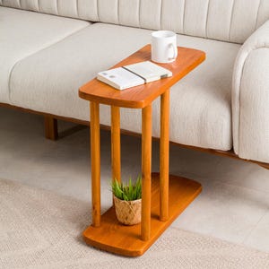 Narrow End Side Coffee Table with Storage

C Shape Couch Side Table | Solid Pine Wood Sofa End Table | Small Space Living Room Furniture

Designed for modern living and small spaces, this C shape narrow side table with storage combines elegance, durability, and functionality. Its slim profile allows it to slide easily under your couch or sofa, making it perfect for compact areas.