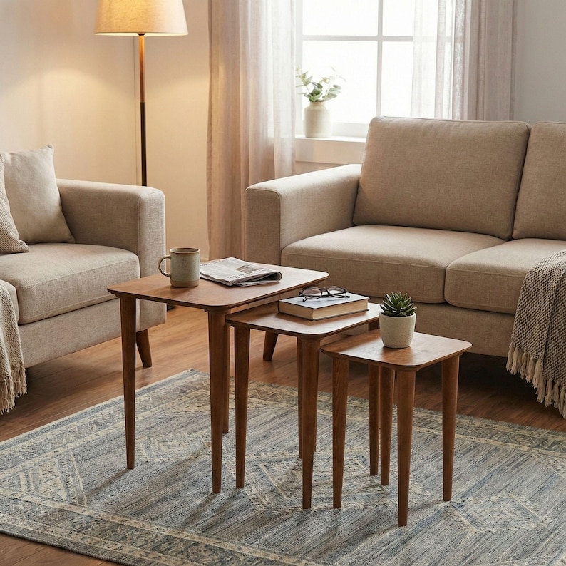 Walnut Wood Nesting End Table Set of 3

Small Side Coffee Table | Mid Century Modern Square Nest Table | Livingroom Furniture

Create a stylish and functional living space with this walnut wood nesting end table set. Perfect for small living rooms, apartments, or cozy corners, these tables save space while adding a modern mid-century charm.

You can purchase the tables as a set of 3, as a single table, or as a pair. Simply select your preferred option from the dropdown menu.