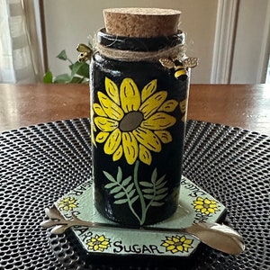 Hand-painted glass sugar jar with marble base.