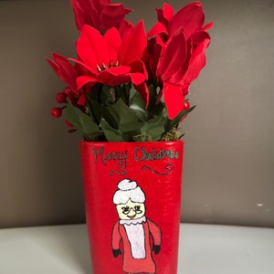 Hand-painted Christmas character themed vase.