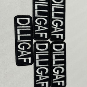 May include: Five black and white embroidered iron-on patches with the text "DILLIGAF" in white.
