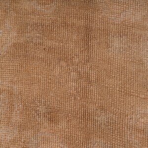 May include: Close-up of a brown textured fabric with a subtle woven pattern.