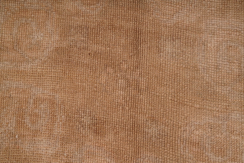 May include: Close-up of a brown textured fabric with a subtle woven pattern.