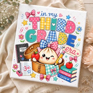 May include: A square canvas print featuring the text 'in my THIRD GRADE era' in colourful, patterned block letters. The design includes a cartoon dumpling in a bamboo steamer, a composition book, a pencil, apples, and a stack of books labelled 'LEARN', 'INSPIRE', and 'GROW', all decorated with bows and stars.