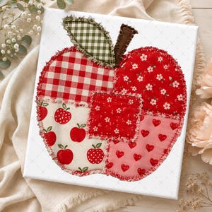May include: A square canvas featuring a large apple-shaped collage made of various fabric patches. The apple includes red and white gingham, red floral, cream with small red apples, and pink with red hearts, all with frayed edges.