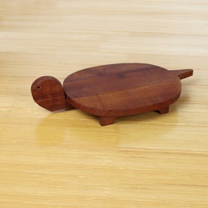 May include: A rustic wooden sign with the text "Welcome to our home" in white lettering. The sign features a distressed finish and a simple, inviting design, perfect for front door decor.