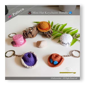 May include: A selection of miniature crochet hat keychains in shades of pink, orange, purple, and white. Each hat is attached to a silver keyring. The image features the text "Mini Hat Keychains Bundle" and "Pattern".