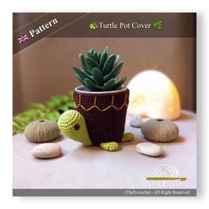 May include: A crocheted turtle pot cover in brown and green with a small succulent plant inside. The pot cover is designed to look like a turtle with a brown shell and green head and legs. The text "Turtle Pot Cover" is visible in the image.