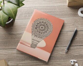 Cuaderno de tapa dura con globos aerostáticos dibujados a mano color crema naranja y cubiertas hinchadas